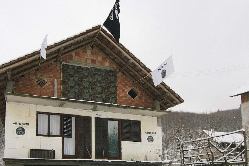 A house in the Bosnian village of Gornja Maoca decorated with Islamic State flags, Jan 26, 2015. -- PHOTO: REUTERS&nbsp;
