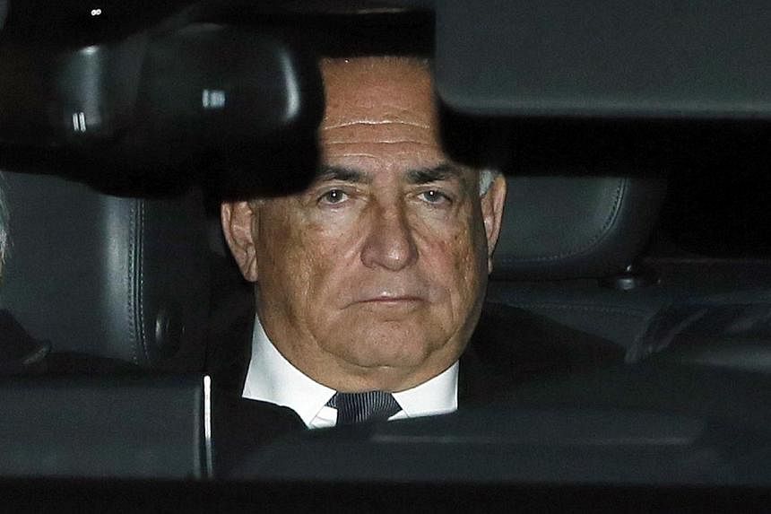 Former IMF head Dominique Strauss-Kahn rides in the backseat of a car as he leaves after the first day of trial in the so-called Carlton Affair, in Lille on Feb 2, 2015. -- PHOTO: REUTERS