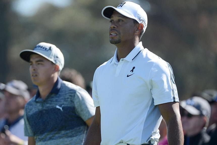 Tiger Woods watches his tee shot on the 10th hole of the north course as Rickie Fowler (left) looks on during the first round of the Farmers Insurance Open at Torrey Pines Golf Course on Feb 5, 2015 in La Jolla, California. -- PHOTO: AFP