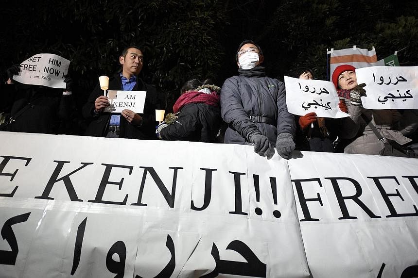 People hold placards during a gathering before the Prime Minister official residence in Tokyo, Japan on Jan 28, 2015.&nbsp;Japanese companies with overseas operations are showing greater interest in seeking advice on security and other threats, after