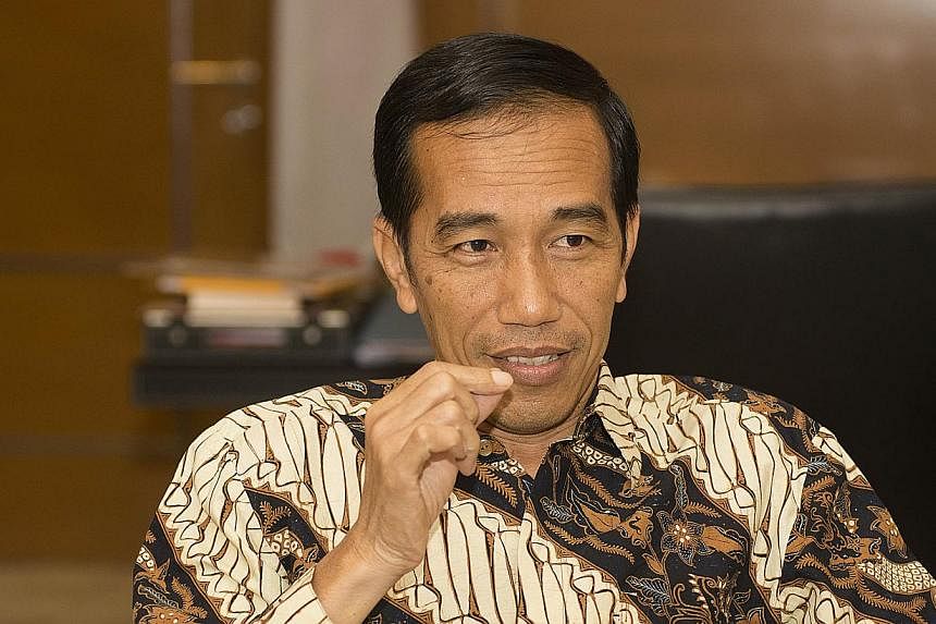 Indonesia's President-elect Joko Widodo.&nbsp;President Joko Widodo is planning a tax amnesty in a bid to convince Indonesians to bring back funds held offshore as he seeks to narrow the current-account deficit. -- PHOTO: SPH FILE
