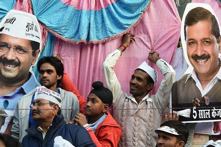 Indian supporters of Aam Admi Party (AAP) wait for party chief Arvind Kejriwal during an election rally in New Delhi on Feb 4, 2015. Voters went to the polls in India's capital on Saturday, Feb 7, 2015,&nbsp;with firebrand&nbsp;Mr Kejriwal looking to