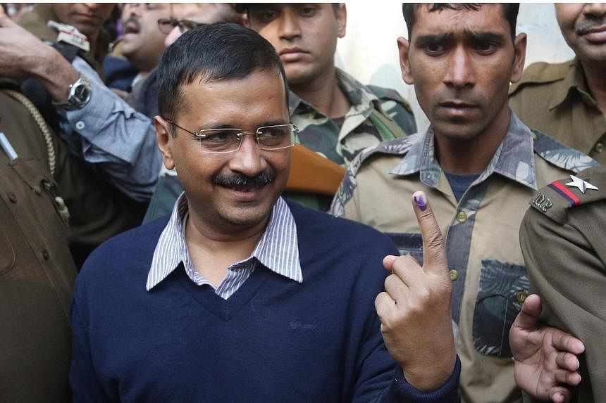 Aam Admi Party's (AAP) Chief Ministerial candidate Arvind Kejriwal shows his ink-marked finger after casting his vote at a polling station in New Delhi, India, Feb 7, 2015. India's Narendra Modi was forecast to suffer the first major setback of his p