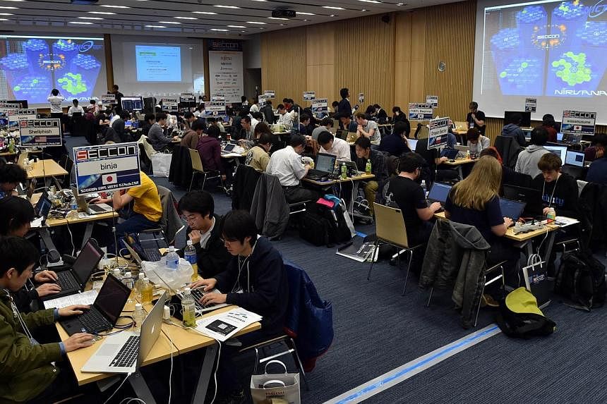 Participants from seven nations and regions from China, Japan, Poland, Russia, South Korea, Taiwan, and the United States compete in their hacking skills at the final rounds of the Security Contest 2014, SECCON on Feb 7, 2015. -- PHOTO: AFP