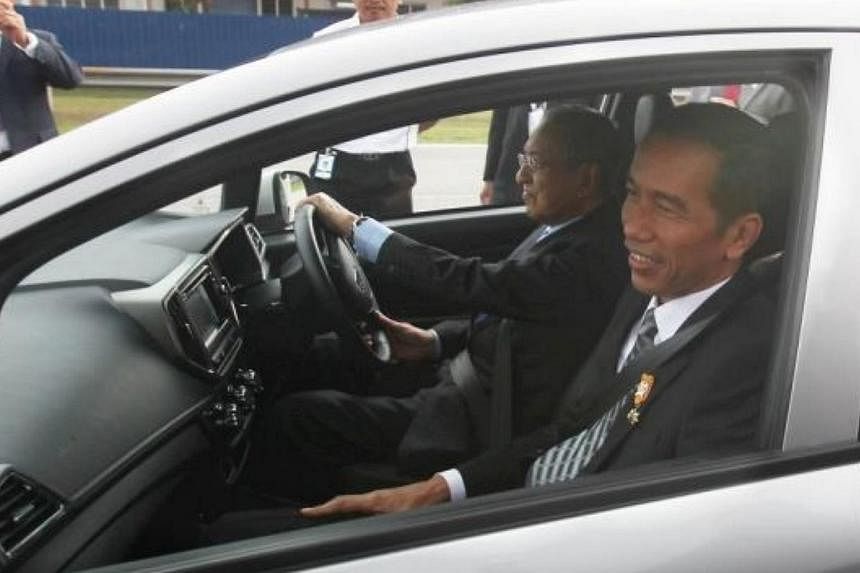 President of indonesia Joko Widodo taking a ride in the new proton Iriz driven by Proton Chairman Tun Mahathir Mohamad during his visit to the Proton centre of Excellence in Shah Alam. -- PHOTO: THE STAR/ ASIA NEWS NETWORK