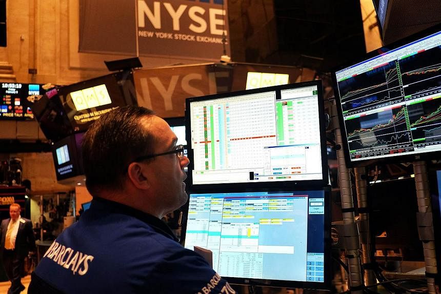 A trader works on the floor of the New York Stock Exchange (NYSE) on Feb 6, 2015, in New York. -- PHOTO: AFP