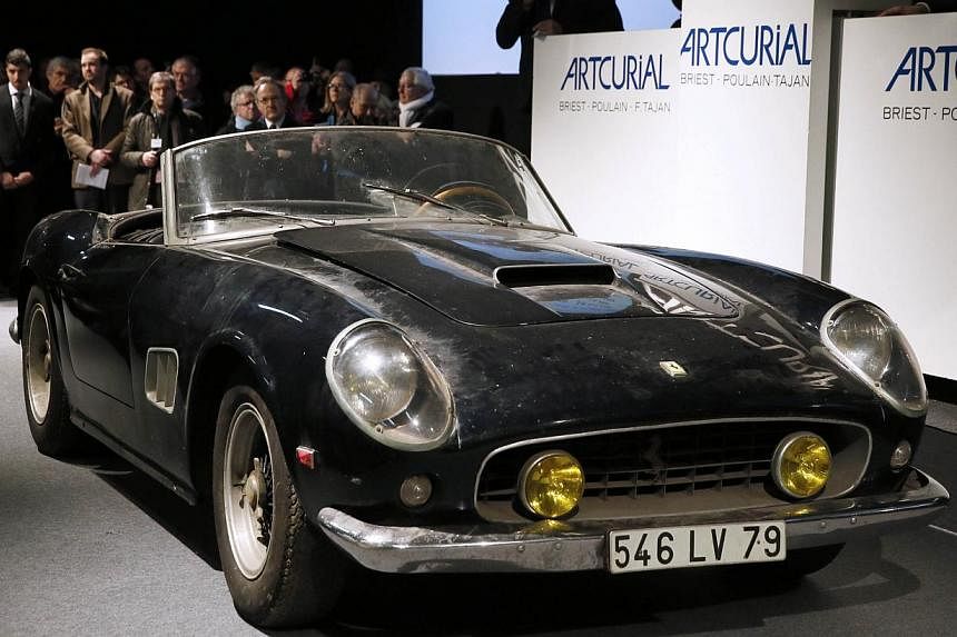 An ultra-rare Ferrari that once belonged to actor Alain Delon and was discovered rusting under a pile of old magazines on a French farm fetched €14.2 million (S$21 million) at auction on Friday. -- PHOTO:&nbsp;AFP&nbsp;