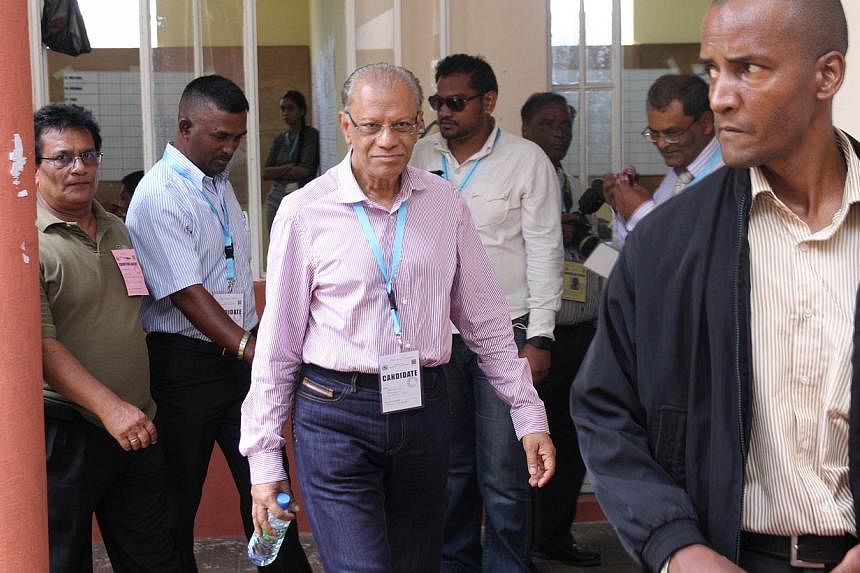 Navinchandra Ramgoolam (centre), then prime minister of Mauritius, leaves a counting centre during polls last year, on Dec 11, 2014. - PHOTO: AFP