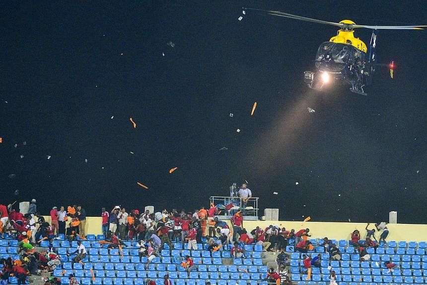 A police helicopter is used to disperse rioting fans from pelting Ghanaian fans with projectiles during the 2015 Africa Cup of Nations semi final match between Ghana and Equatorial Guinea at the Malabo Stadium, Malabo, Equatorial Guinea on Feb 5, 201