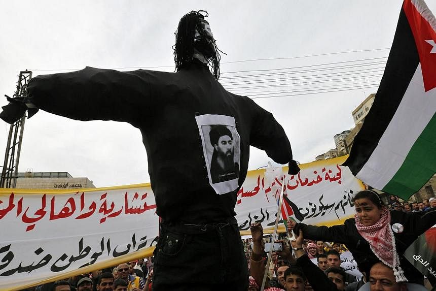 Jordanian protesters carry an effigy of leader of the militant Islamic State Abu Bakr al-Baghdadi, during a march after Friday prayers in downtown Amman on Feb 6, 2015. -- PHOTO: REUTERS