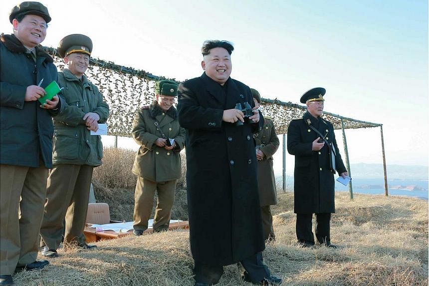 An undated handout picture released by the official North Korean Central News Agency (KCNA) on Feb 7, 2015 shows North Korean leader Kim Jong-un watching the test-firing of a new anti-ship rocket at an undisclosed location. -- PHOTO: EPA
