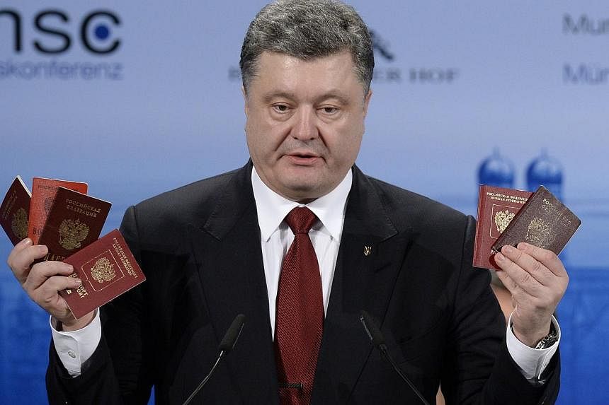 Ukraine President Petro Poroshenko on Saturday brandished in front of world leaders several passports (above) taken from Russian soldiers in what he said was proof of Moscow's "presence" in his country. -- PHOTO: AFP
