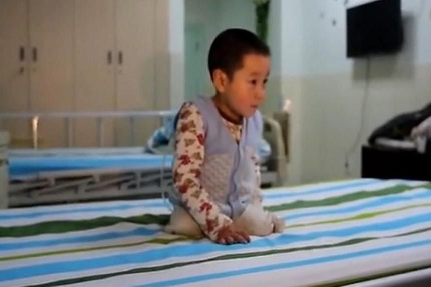 Xiao Feng, as the boy is affectionately known in Chinese media, was filmed prancing and flipping on his hospital bed in the central Hubei province using his arms and the stumps of what used to be his legs. -- PHOTO: YOUTUBE SCREENGRAB