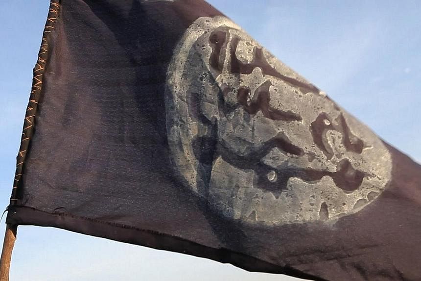 A Boko Haram flag flutters from an abandoned command post in Gamboru deserted after Chadian troops chased them from the border town on Feb 4, 2015. -- PHOTO: AFP