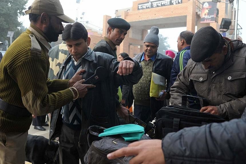 Indian border and customs personnel screen Pakistani nationals travelling on the Delhi-Lahore bus on Jan 8, 2015. India and Pakistan have suspended trade across their de facto border in the disputed territory of Kashmir after Indian authorities detai