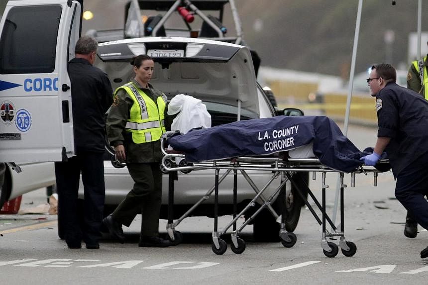 A Los Angeles County coroner worker loading a victim into a van at the scene of a four-car crash involving Olympic gold medalist and reality TV star Bruce Jenner in Malibu, California on Feb 7, 2015.&nbsp;-- PHOTO: REUTERS