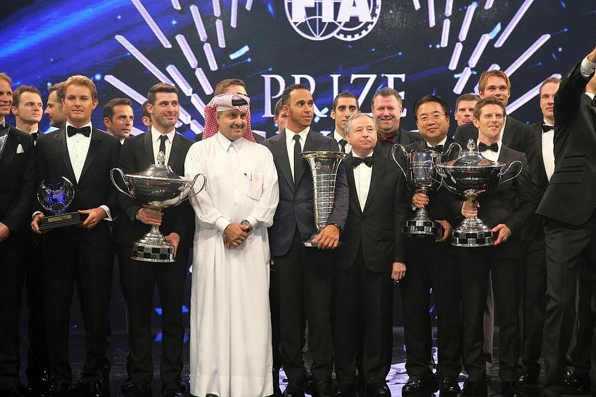 Formula One British driver Lewis Hamilton (centre) of Mercedes AMG Petronas, FIA President Jean Todt (centre right) and Head of Qatar Motor and Motorcycle Federation Nasser bin Khalifa al-Attiyah (centre left) posing for a group picture with other pr