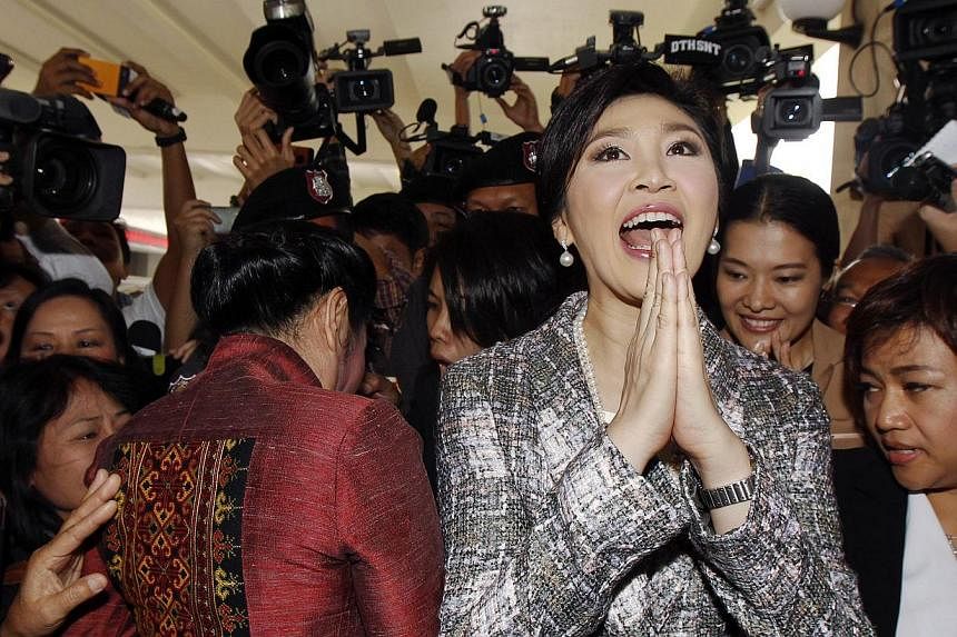 Ousted former Thai Prime Minister Yingluck Shinawatra giving a traditional greeting as she leaves parliament after delivering a statement during the National Legislative Assembly meeting in Bangkok, in this Jan 22, 2015, file photo.&nbsp;-- PHOTO: RE
