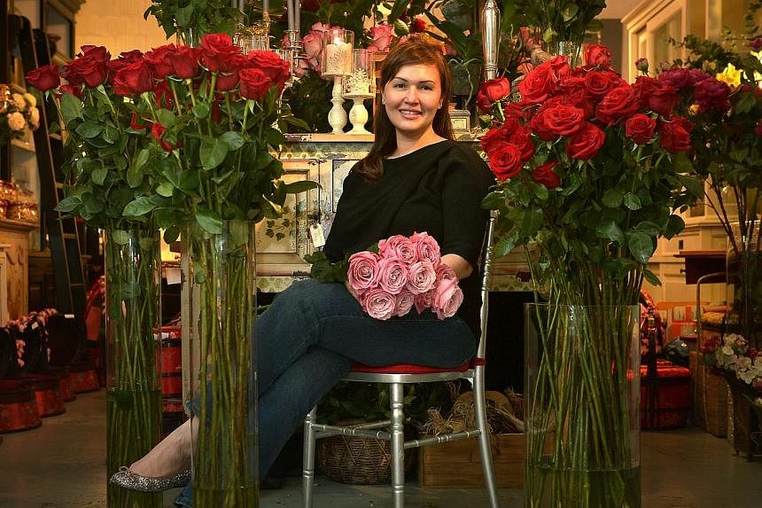 Floret and Teddies' Ms Tara Chia with the roses, which are 1.3m to 1.5m tall. One man has ordered 100 stems.