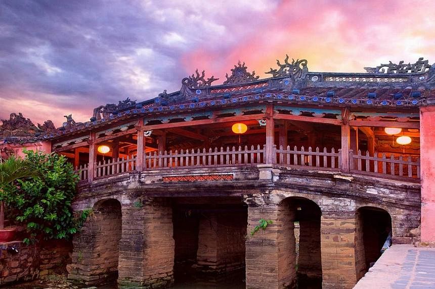 In the ancient port city of Hoi An, travellers can take in the sights of the pedestrian streets (left) as well as the Japanese bridge (above), which dates from the 16th century. Da Nang boasts long strips of white sand beaches overlooking the South C