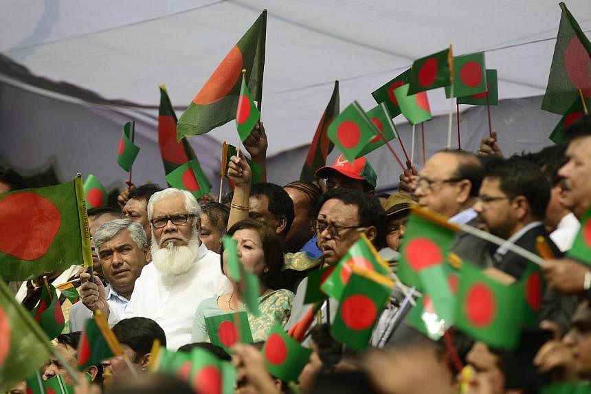 Bangladesh businessmen wave the national flag as they take part in a protest against an ongoing nationwide strike and blockade called by the Bangladesh Nationalist Party (BNP)-led alliance, which&nbsp;they say has cost the economy nearly S$13 billion