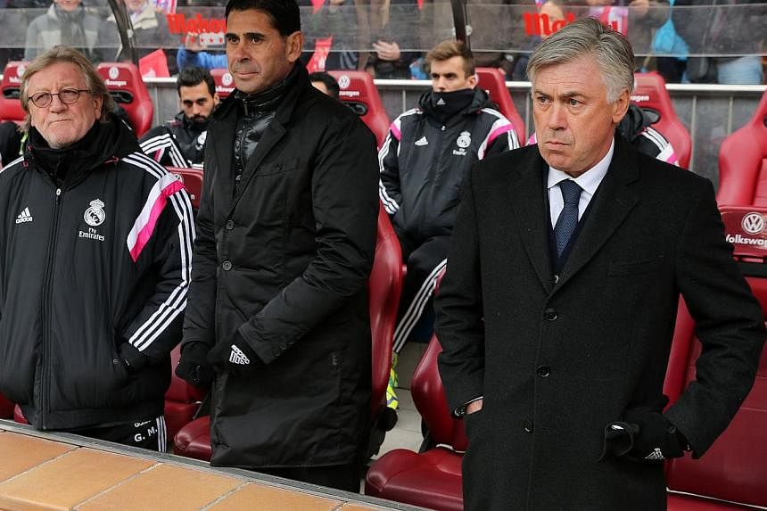 Real Madrid's Italian head coach Carlo Ancelotti (right) looks on prior to his team's derby match against Atletico Madrid on Feb 7, 2015. Atletico won 4-0. -- PHOTO: AFP