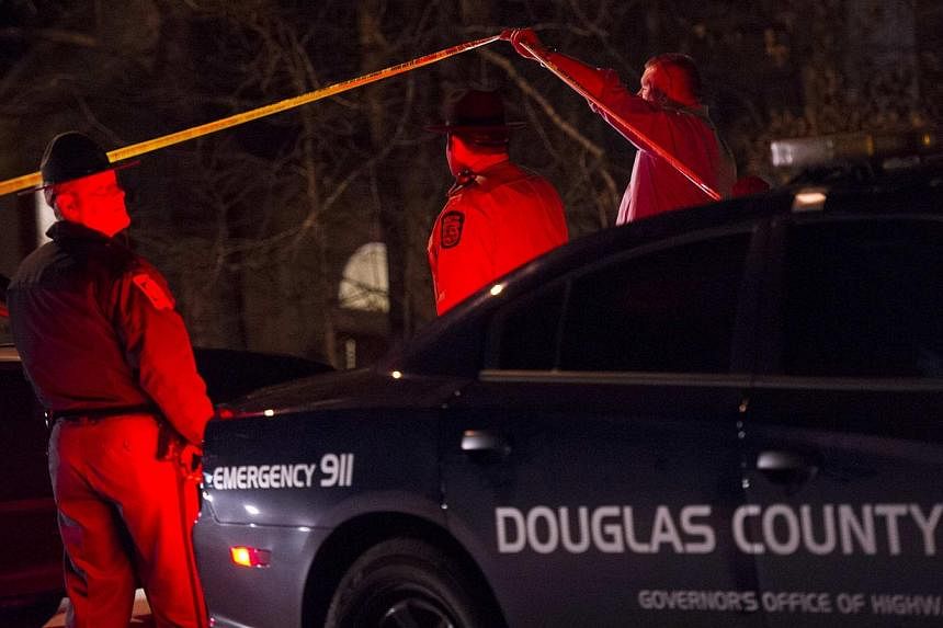 Douglas County Sheriff's Office deputies and investigators outside the crime scene of a home in a suburban neighbourhood in Douglasville, Georgia, on Feb 7, 2015. -- PHOTO: REUTERS