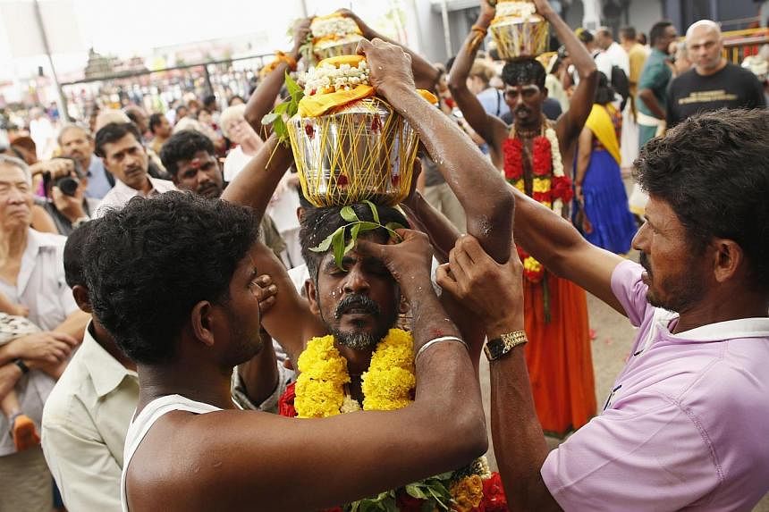 Devotees carrying milk pots over their heads during Thaipusam on Feb 3, 2015. -- PHOTO: REUTERS