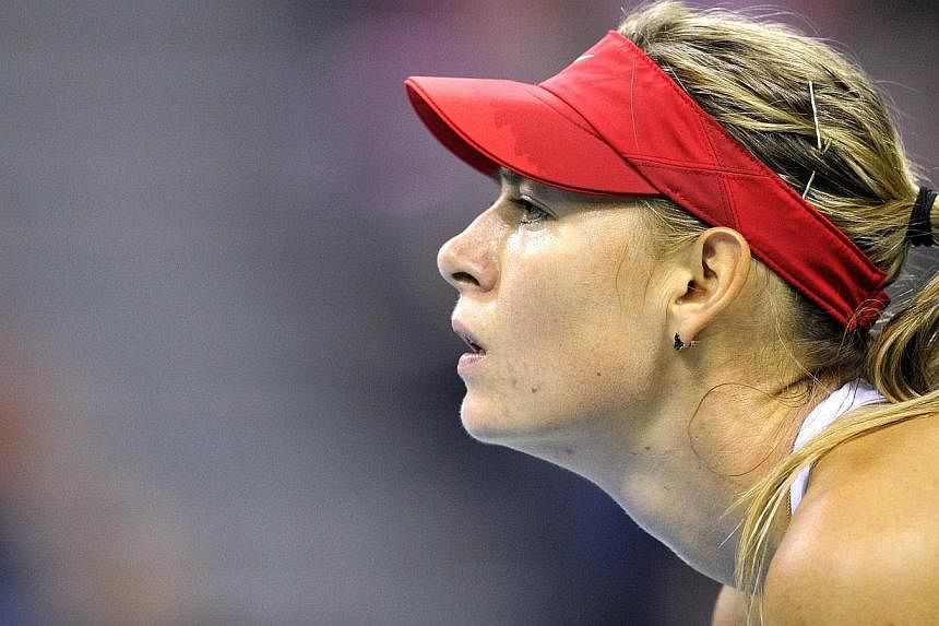Maria Sharapova (above) defeated Urszula Radwanska 6-0, 6-3 as Russia took a 2-0 lead over Poland in the Fed Cup World Group Saturday with the superstar taking a first step towards the Rio Olympics. -- PHOTO: AFP