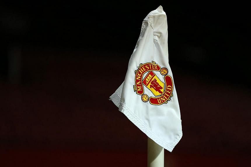 The Manchester United club logo is seen on a corner flag on the Old Trafford pitch.&nbsp;A player from from the club was allegedly filmed by team-mates as he and a woman engaged in a "sex act" in the toilets of a nightclub. -- PHOTO:&nbsp;REUTERS