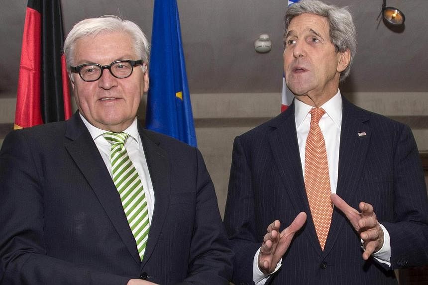 German Foreign Minister Frank-Walter Steinmeier (left) with US Secretary of State John Kerry (right) at the Munich Security Conference in Germany, Feb 7, 2015. -- PHOTO: AFP