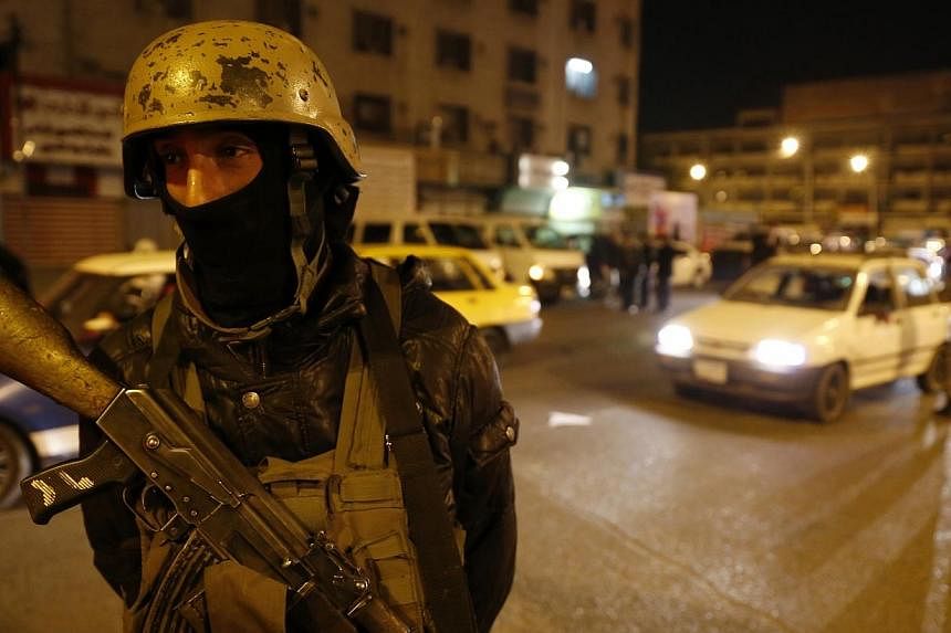 A member of Iraq's security forces standing guard at Tahrir Square in Baghdad on Feb 8, 2015.&nbsp;A suicide bomber struck in a Shi'ite-majority area of north Baghdad on Monday, killing at least 13 people. -- PHOTO: REUTERS
