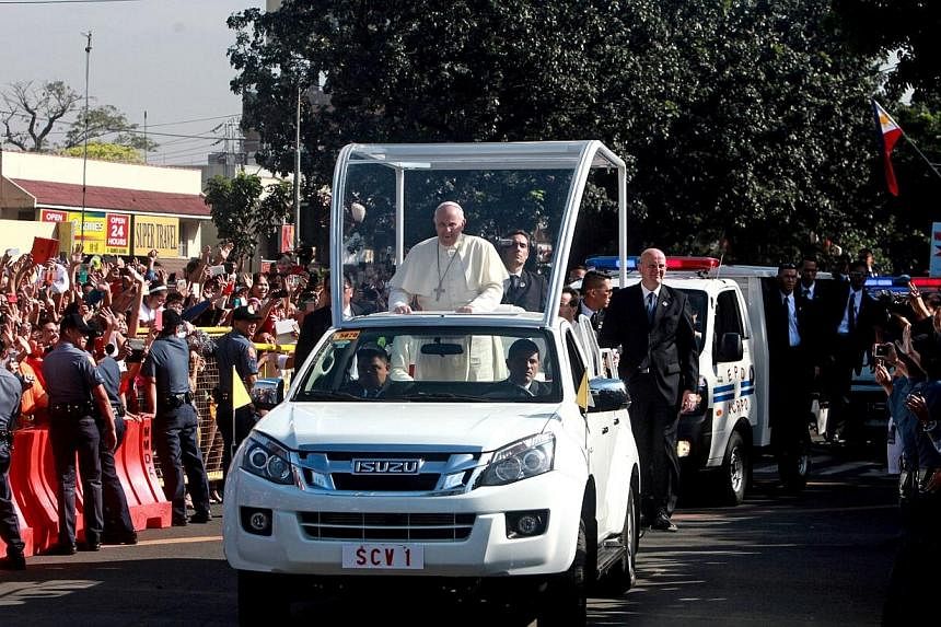 Pope Francis (centre) passes Catholic devotees in his "popemobile" on his way to Villamor Airbase in Manila on Jan 19, 2015. A&nbsp;former commando commander revealed that slain&nbsp;Malaysian terrorist Marwan and the Al-Qaeda-linked terror group Jem