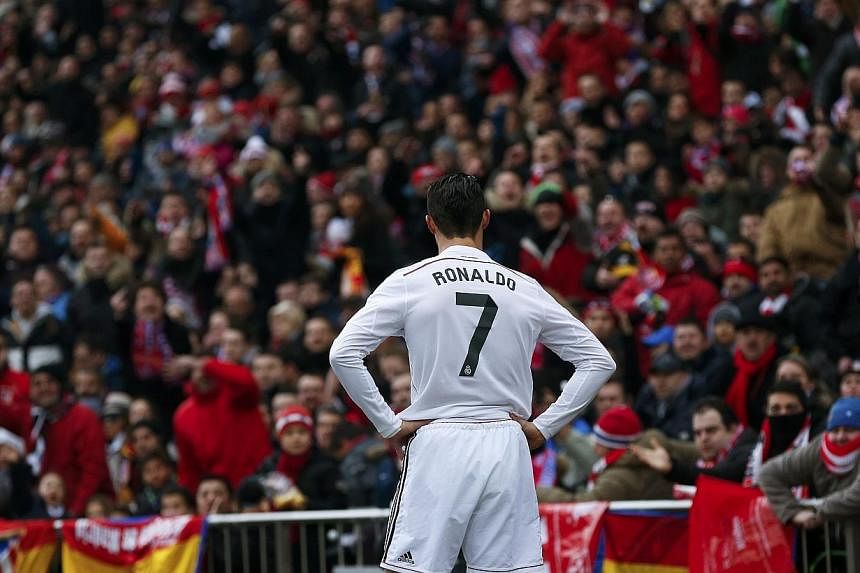 Real Madrid's Cristiano Ronaldo reacts during their Spanish first division soccer match against Atletico Madrid at the Vicente Calderon stadium in Madrid, on Feb 7, 2015. The football star drew criticism in the changing room by partying for his 30th 