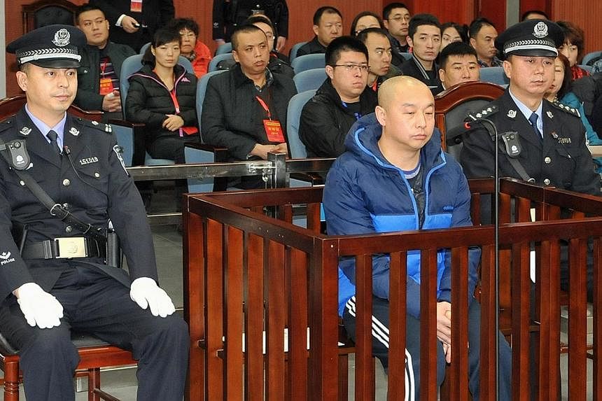 Zhao Zhihong (centre), a man who confessed to murdering a woman in China 18 years ago, went on trial in the Intermediate People's Court in Hohhot, north China's Inner Mongolia region on Jan 5, 2015, three weeks after a court cleared the teenager who 