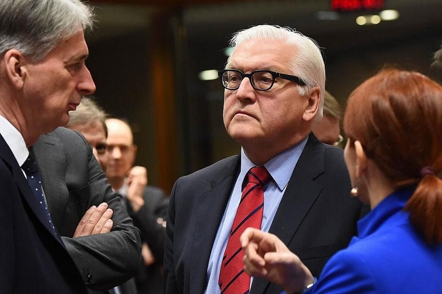 Germany's Foreign Minister Frank-Walter Steinmeier (centre) speaks with his British counterpart Philip Hammond (left) and Estonian counterpart Keit Pentus-Rosimannus during a EU foreign affairs council at the European Council, in Brussels, on Feb 9, 