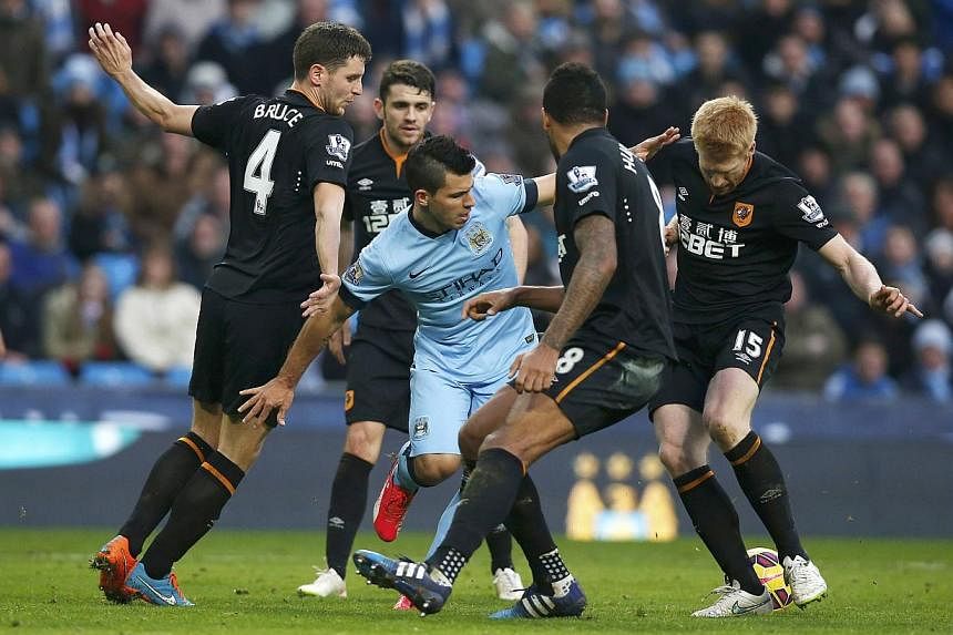 Sergio Aguero of Manchester City is surrounded by Hull City defenders during their English Premier League soccer match at the Etihad Stadium, Manchester on Feb 7, 2015.&nbsp;-- PHOTO: REUTERS