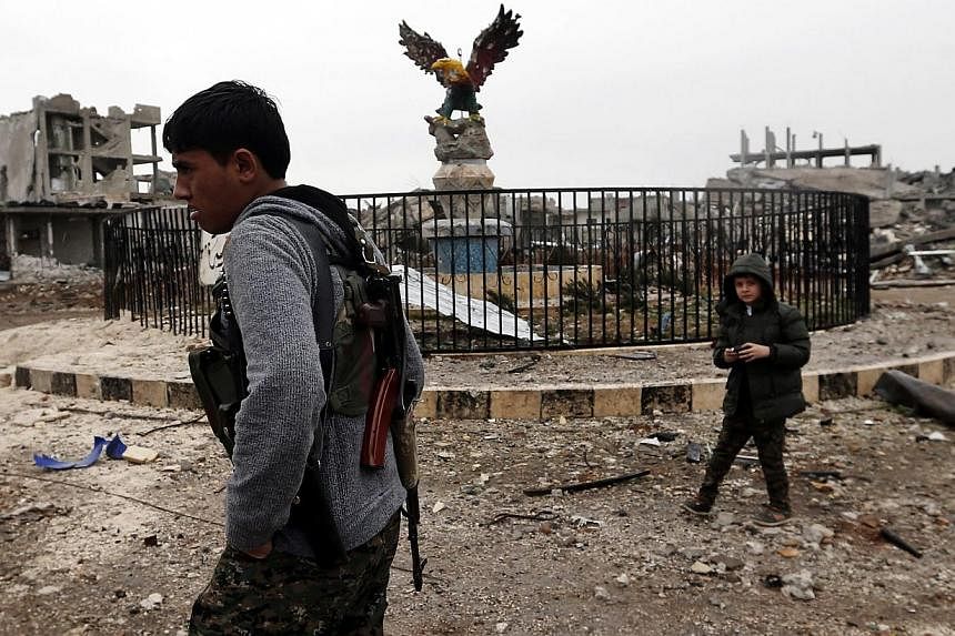 A young member of Syrian Kurdish People's Defence Units (YPG) patrols Kobane, Syria on Jan 30, 2015, after Islamic State in Iraq and Syria (ISIS) militants were pushed out of the city.&nbsp;Syria will not allow foreign ground troops on its territory 
