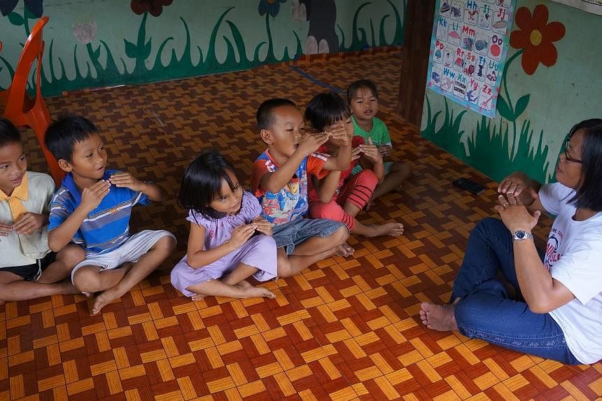 About 20 children from Kampung Tiku walk an hour each day through the jungle to get to school in the neighbouring village of Buayan and make the return journey home. (Below) Children at the Buayan kindergarten.