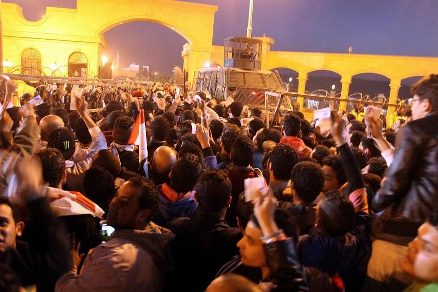 Egyptian Zamalek fans trying to enter a football match outside a Cairo stadium were blocked by a police barricade on Feb 8, 2014. -- PHOTO: EPA
