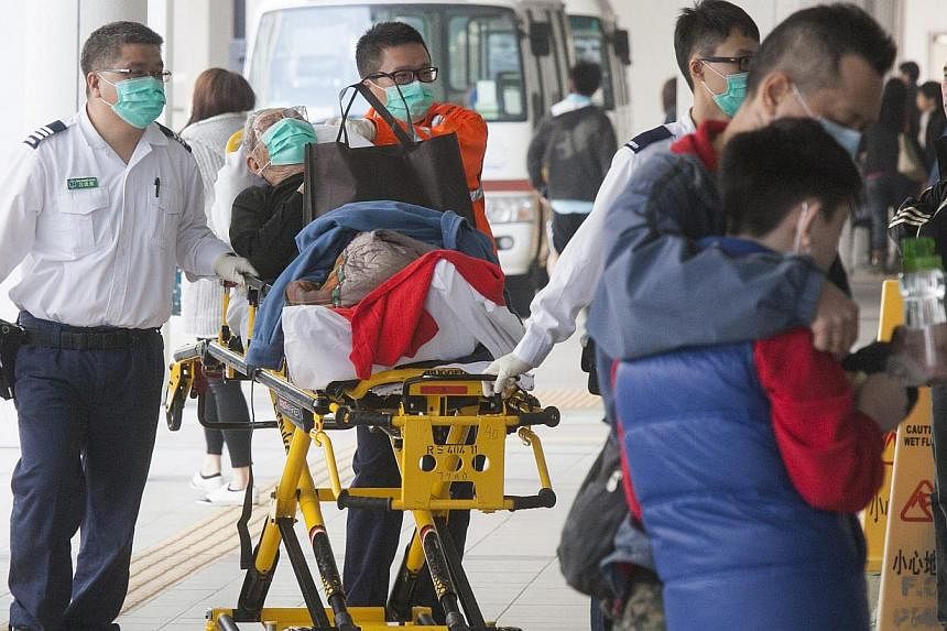 Patients and health workers wearing face masks to protect themselves against infectious diseases at the Princess Margaret Hospital in Kowloon, Hong Kong, on Feb 3, 2015. The H3N2 outbreak has led to the hospitalisation of some 218 patients thus far, 