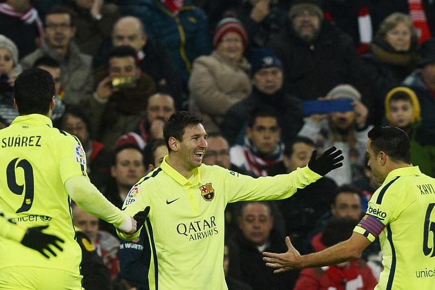 (From left) Barcelona's Luis Suarez, Lionel Messi and Xavi Hernandez celebrating a goal by Messi during their match against Athletic Bilbao at San Mames stadium in Bilbao on Feb 8, 2015. -- PHOTO: REUTERS
