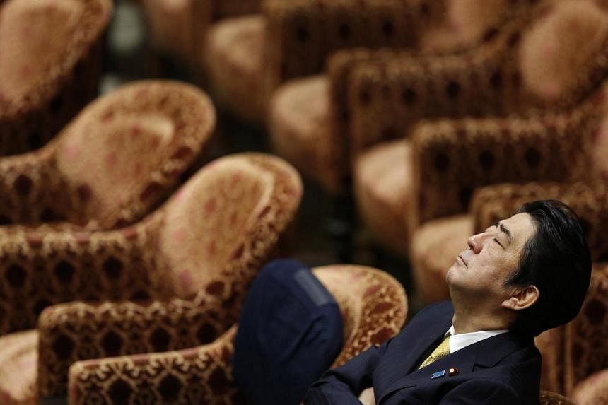 Japan's Prime Minister Shinzo Abe closes his eyes during a Lower House committee session at the parliament in Tokyo on February 4, 2015. The world might prefer the Japanese government to take a stronger stand against terrorism, but Prime Minister Shi
