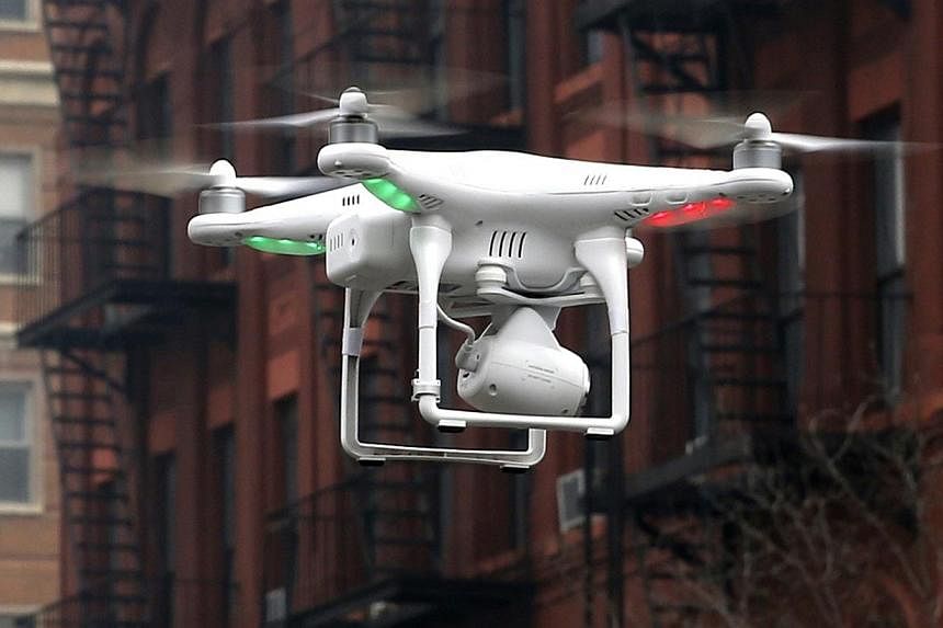 A camera drone operated by a civilian flies near the scene where two buildings were destroyed in an explosion in New York, in this file photo taken on March 12, 2014.&nbsp;Between 20 and 30 per cent of 70 applications for permits to fly drones in Sin
