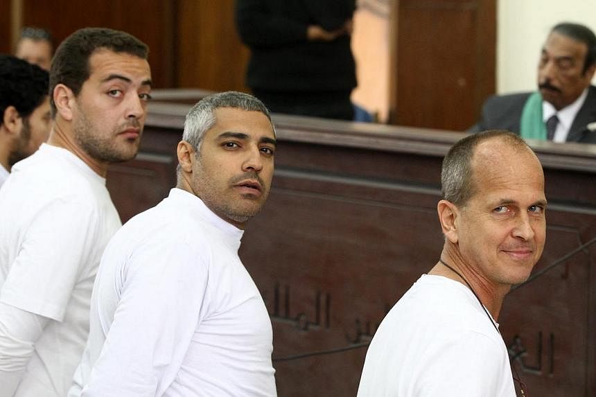 (From right) Australian journalist Peter Greste, Canadian-Egyptian journalist&nbsp;Mohamed Fahmy and journalist&nbsp;Baher Mohamed&nbsp;stand in front of the judge's bench during their trial for allegedly supporting a terrorist group and spreading fa