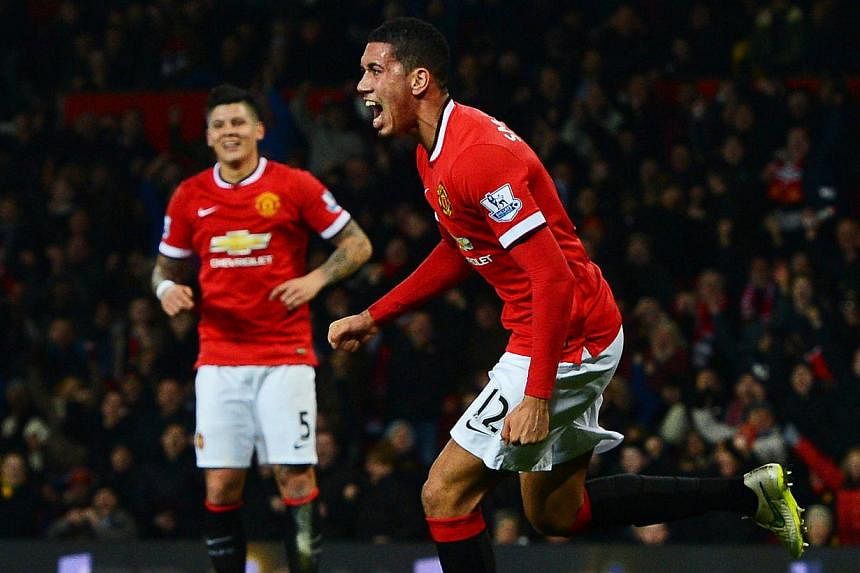 Manchester United's Chris Smalling (right) celebrating after scoring against Burnley FC at Old Trafford in Manchester, on Feb 11, 2015. -- PHOTO: EPA