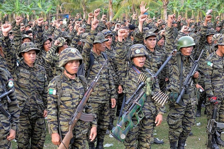 Moro Islamic Liberation Front (MILF) rebels shout slogans&nbsp;while gathered inside their camp at Camp Darapanan in the town of Sultan Kudarat in Mindanao on March 27, 2014. Muslim rebels in the Philippines promised the government on Thursday, Feb 1