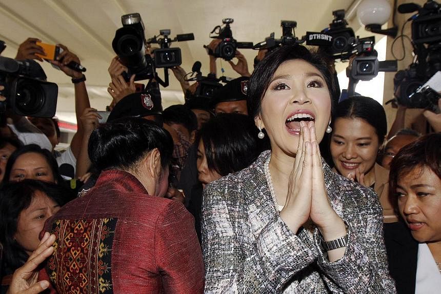 Ousted former Thai Prime Minister Yingluck Shinawatra gives a traditional greeting as she leaves parliament in Bangkok on&nbsp;Jan 22, 2015. Thailand's junta chief on&nbsp;Thursday, Feb 12, 2015,&nbsp;said the military is keeping such a close eye on 