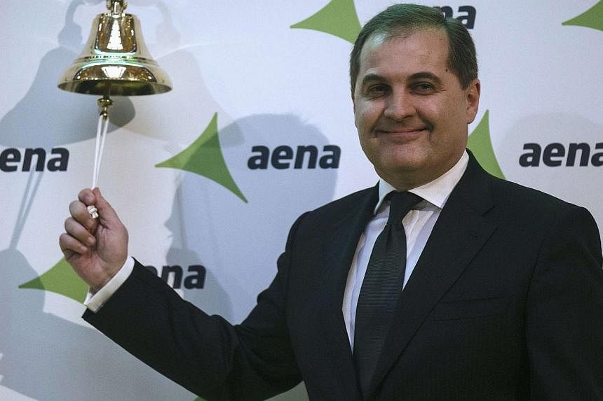 Jose Manuel Vargas Gomez, president of Spanish airports group Aena, poses ringing a bell during their stock market debut at the bourse in Madrid Feb 11, 2015. -- PHOTO: REUTERS