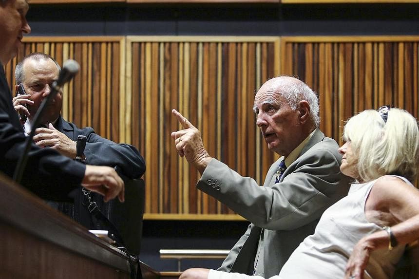 Former Grand Slam doubles champion Bob Hewitt (second right) gestures ahead of court proceedings at the South Gauteng High Court in Johannesburg, Feb 9, 2015. -- PHOTO: REUTERS